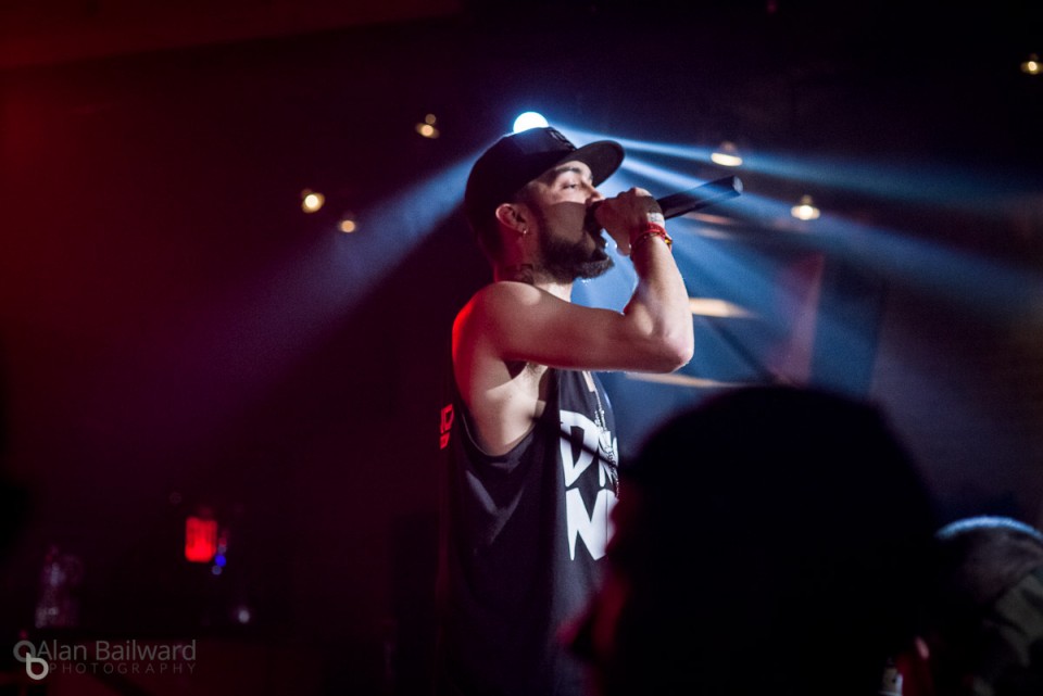 Neph - Hiphop artist on stage with lights behind him