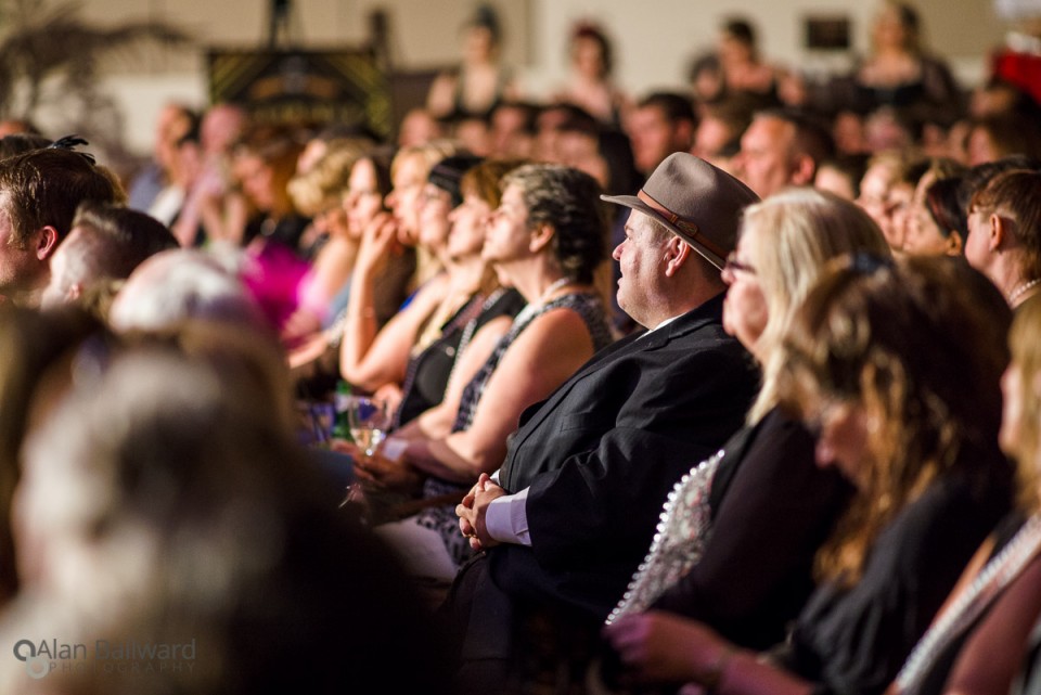 The audience looking on.