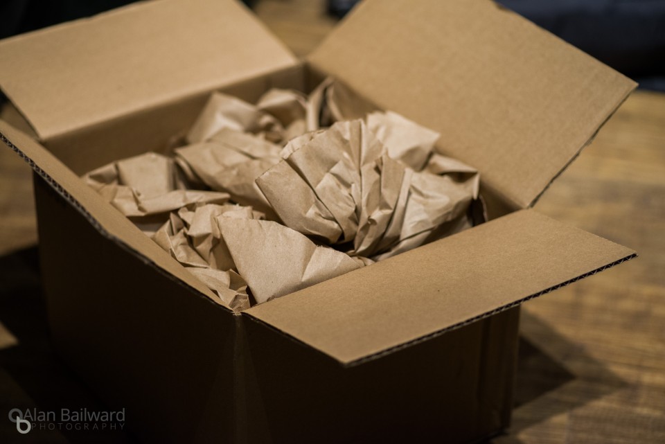 Box open with brown packing paper inside and nothing else visible