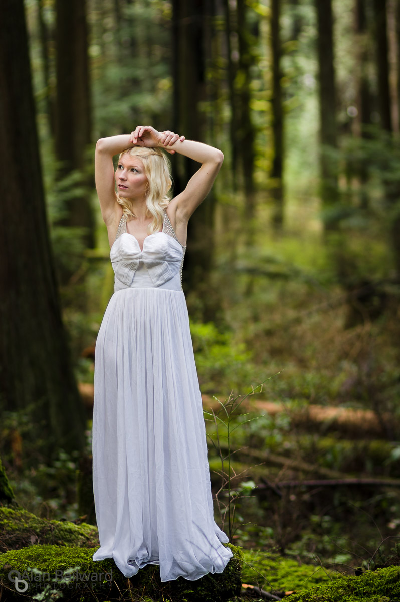 Model in white dress in front of cedar tree